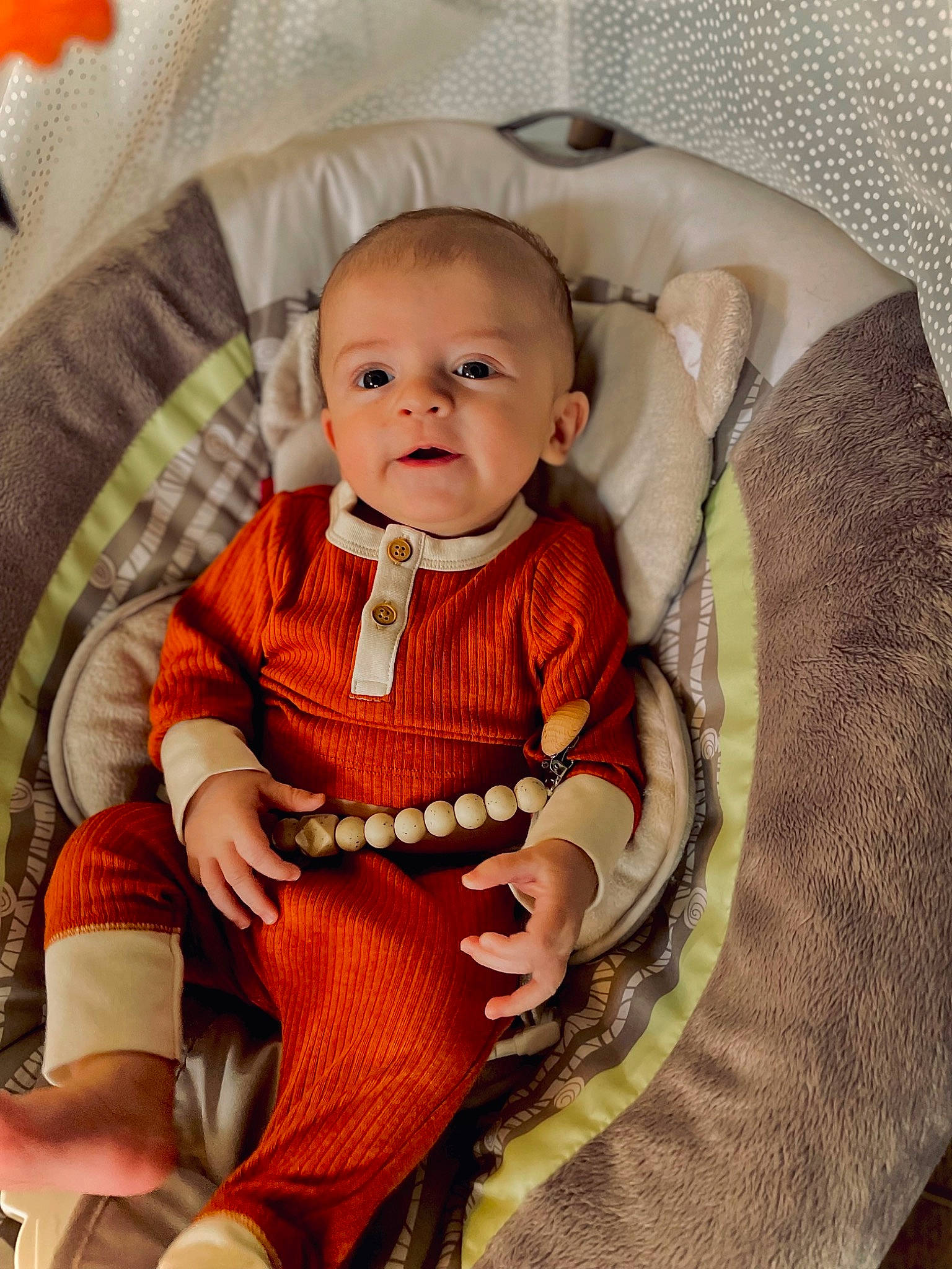 Kayson is registered to the contest to win money with this photo: baby, baby_products, baby_toddler_clothing, chair, cheek, child, clothing, collar, comfort, head, lap, linens, outerwear, pattern, person, product, sitting, sleeve, smile, sock