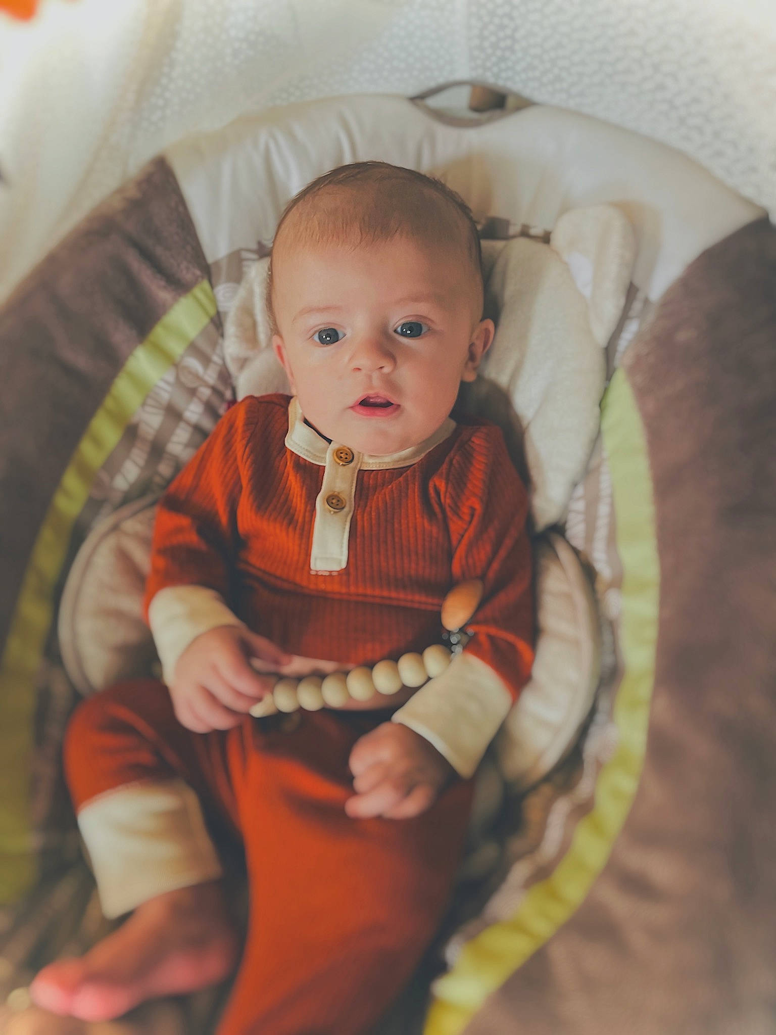 Kayson joined the competition — help win amazing prizes! baby, baby_products, baby_toddler_clothing, chair, cheek, child, circle, comfort, couch, human_body, iris, lap, linens, pattern, person, room, sitting, sleeve, smile, toddler