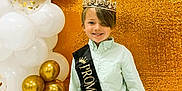 Bennett is registered to the contest to win money with this photo: child, boy, crown, sash, prom_prince, balloons, gold, white, party, celebration, smile, portrait, happy, background, glitter, decorations, standing, clothing, event, indoor