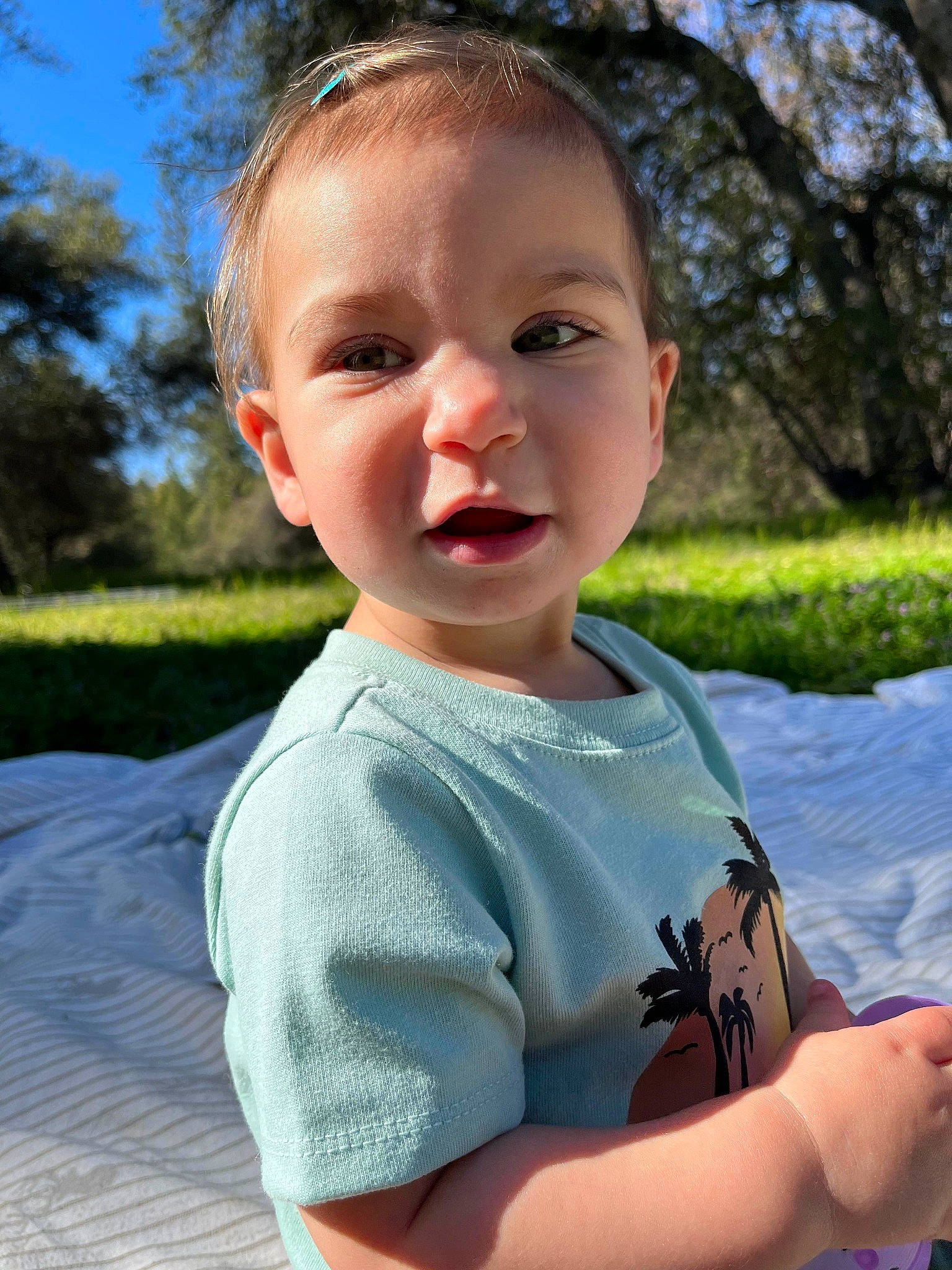 Harper is registered to the contest to win money with this photo: baby, baby_toddler_clothing, cheek, face, fun, gesture, grass, happy, leisure, mouth, neck, nose, person, plant, shoulder, sky, sleeve, summer, t_shirt, toddler