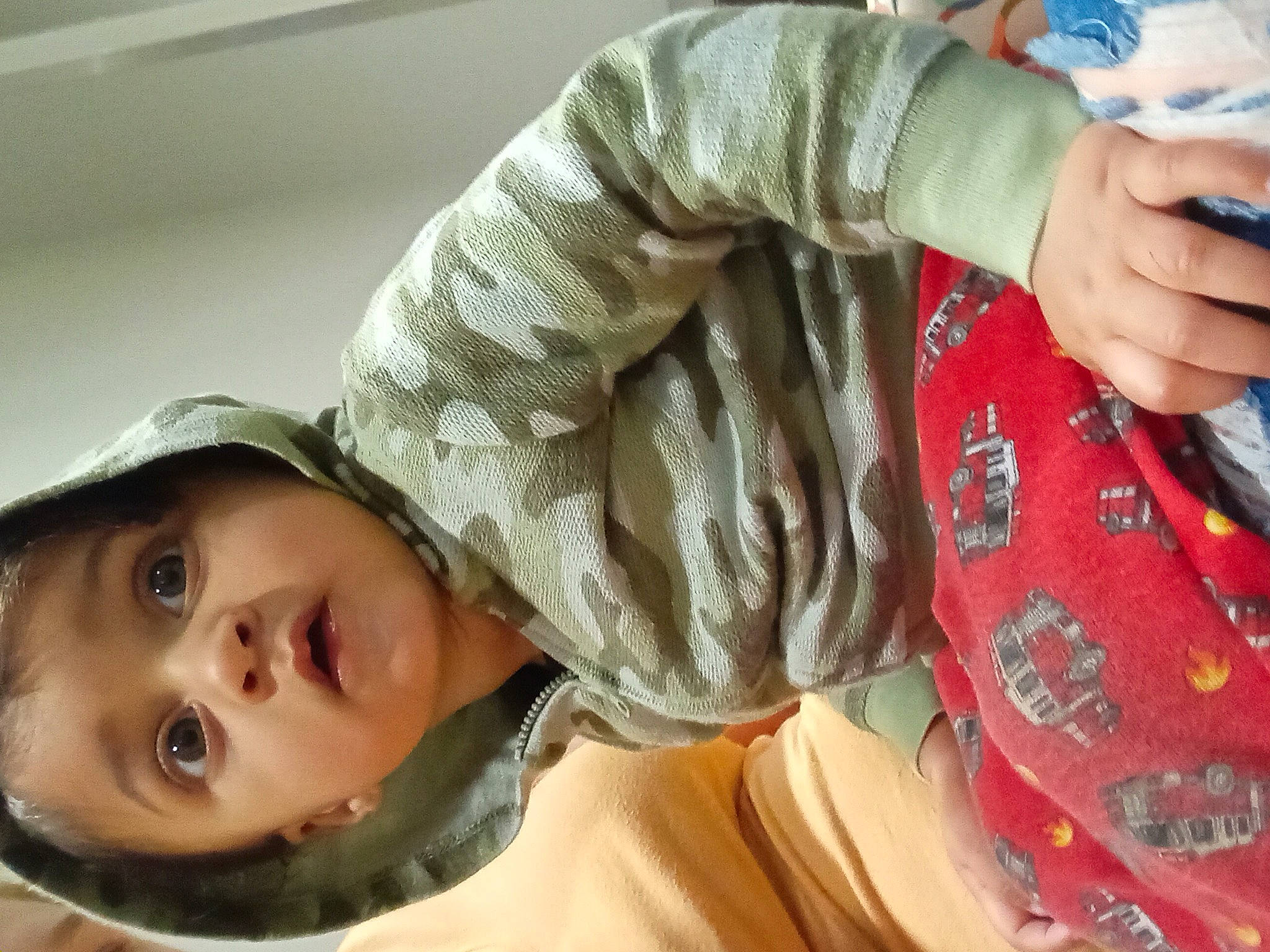 Gabriel is registered to the contest to win money with this photo: baby, cap, cheek, child, comfort, elbow, eyelash, fun, gesture, hand, happy, hat, human_body, nail, pattern, person, sleeve, surprise, thumb, toddler