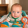 baby, child, infant, blue_eyes, baby_walker, toy, indoor, furniture, curious, seated, clothing, striped_shirt, colorful, face, portrait, young_child, cute, hands, expression, home