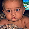 Myles is registered to the contest to win money with this photo: baby, infant, blue_eyes, blanket, bedroom, portrait, child, face, expression, indoor, skin, hair, curious, young, person, closeup, comfort, soft_lighting, candid, resting