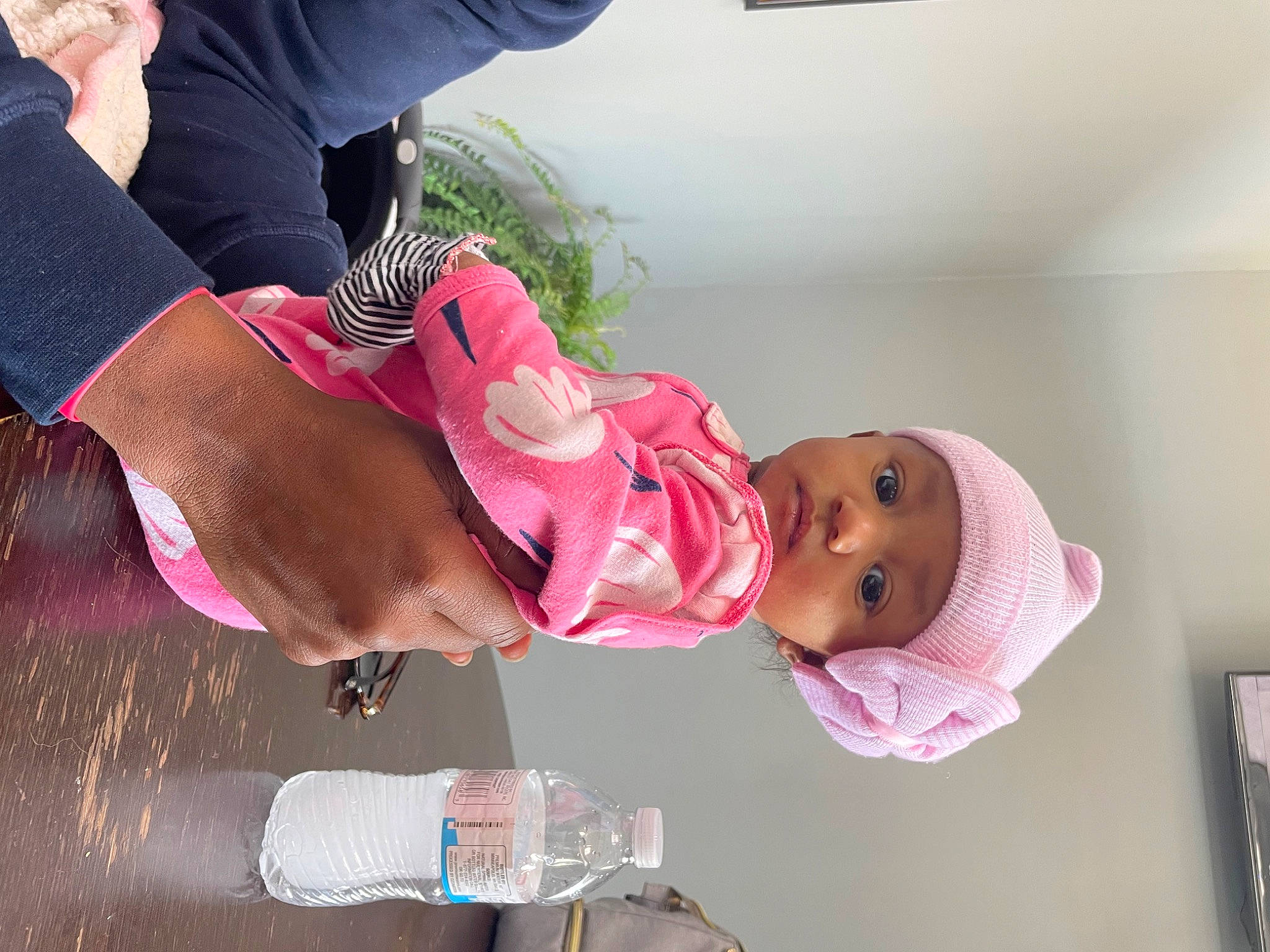 Royale is registered to the contest to win money with this photo: arm, baby, baby_products, baby_toddler_clothing, bottle, child, event, fun, gesture, happy, headwear, leisure, magenta, person, pink, plant, plastic_bottle, thigh, toddler, water