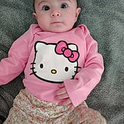 Jaliah is registered to the contest to win money with this photo: baby, child, infant, pink_clothing, hello_kitty, floral_pants, blanket, lying_down, wide_eyes, curious_expression, soft_texture, indoors, person, cute, portrait, young_child, casual, comfortable, baby_girl, clothing