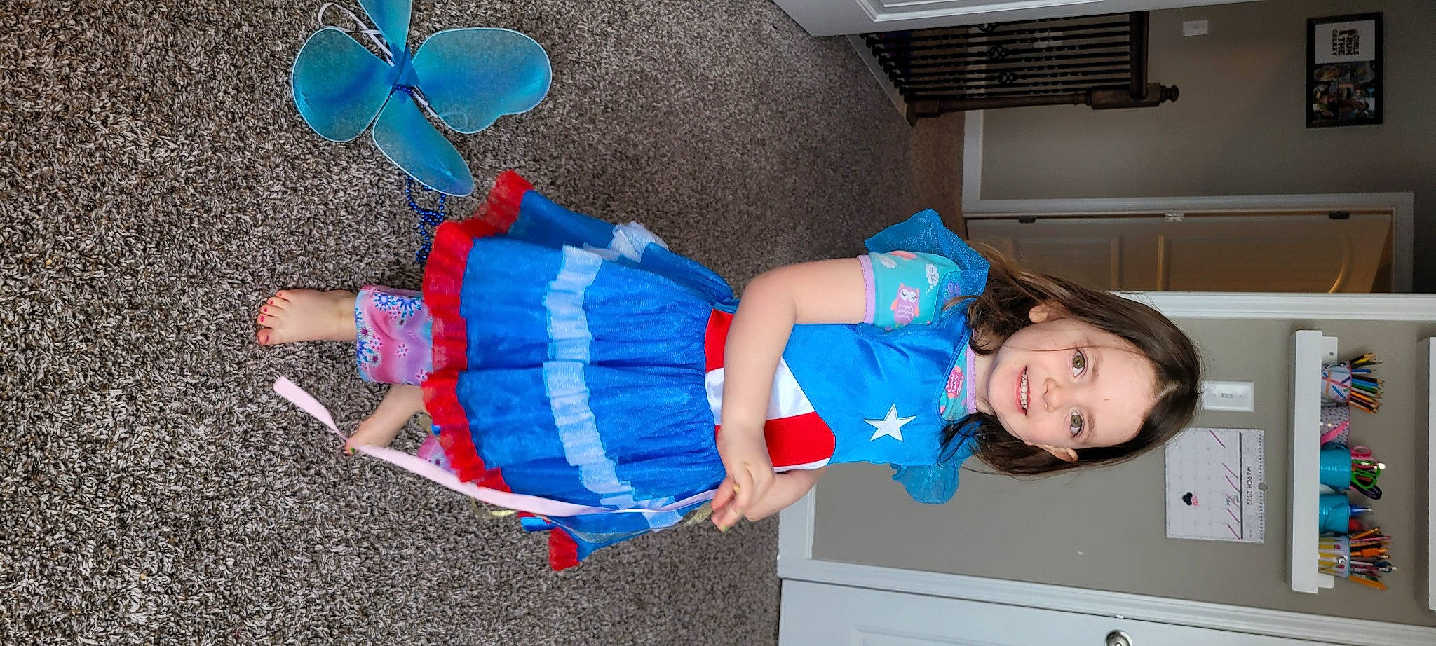 Guinevere is registered to the contest to win money with this photo: arthropod, azure, baby_toddler_clothing, balloon, blue, butterfly, cabinetry, child, costume, drawer, dress, electric_blue, fun, happy, insect, joy, leg, moths_and_butterflies, person, pollinator