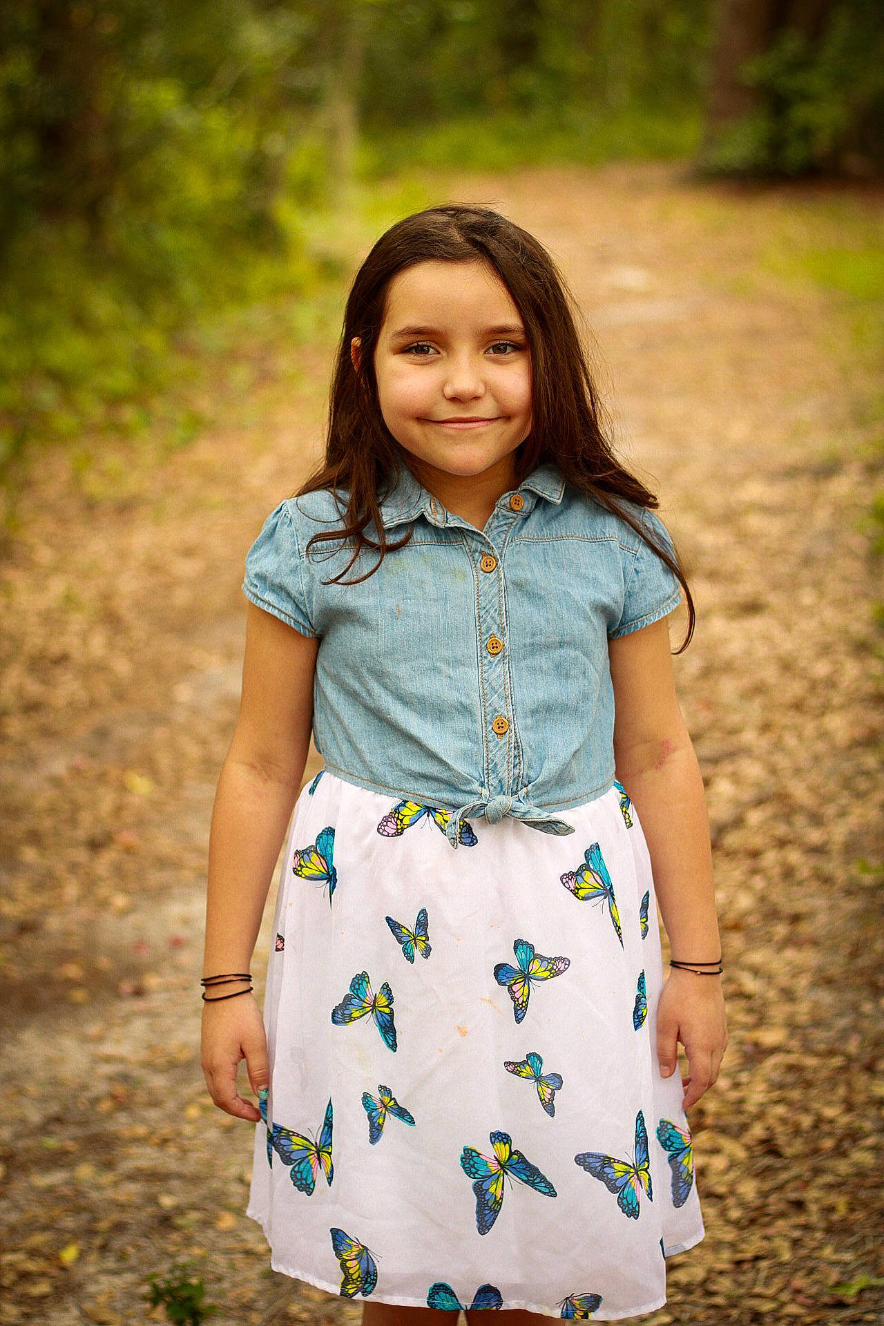 Ariella is registered to the contest to win money with this photo: brown_hair, child, day_dress, dress, face, flash_photography, grass, hair, happy, joy, leaf, pattern, people_in_nature, person, plant, sleeve, smile, spring, summer, t_shirt