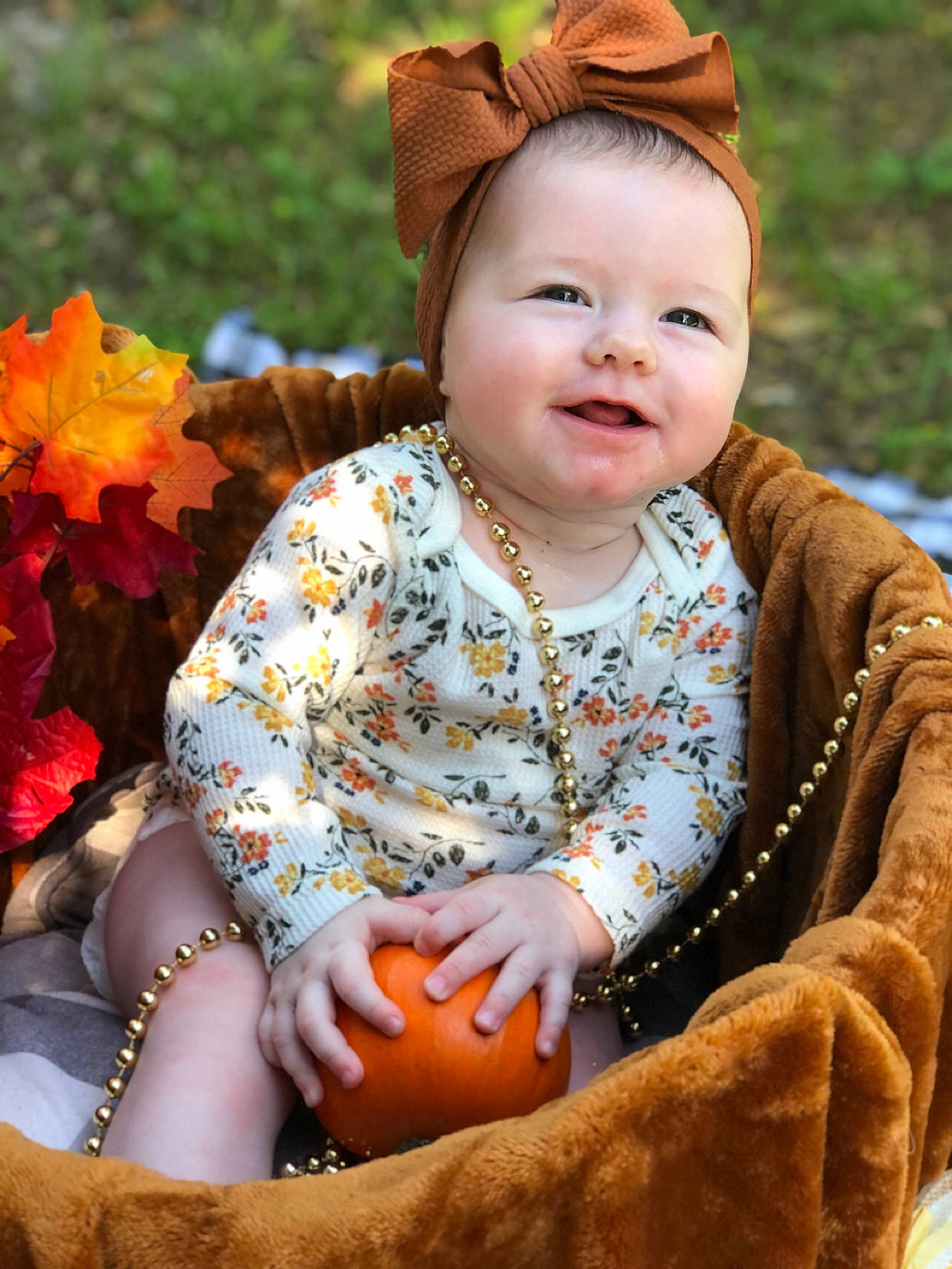 Coraline is registered to the contest to win money with this photo: baby, baby_toddler_clothing, child, dress, eye, face, grass, happy, hat, human_body, joy, leaf, leisure, orange, people_in_nature, person, photograph, plant, skin, smile