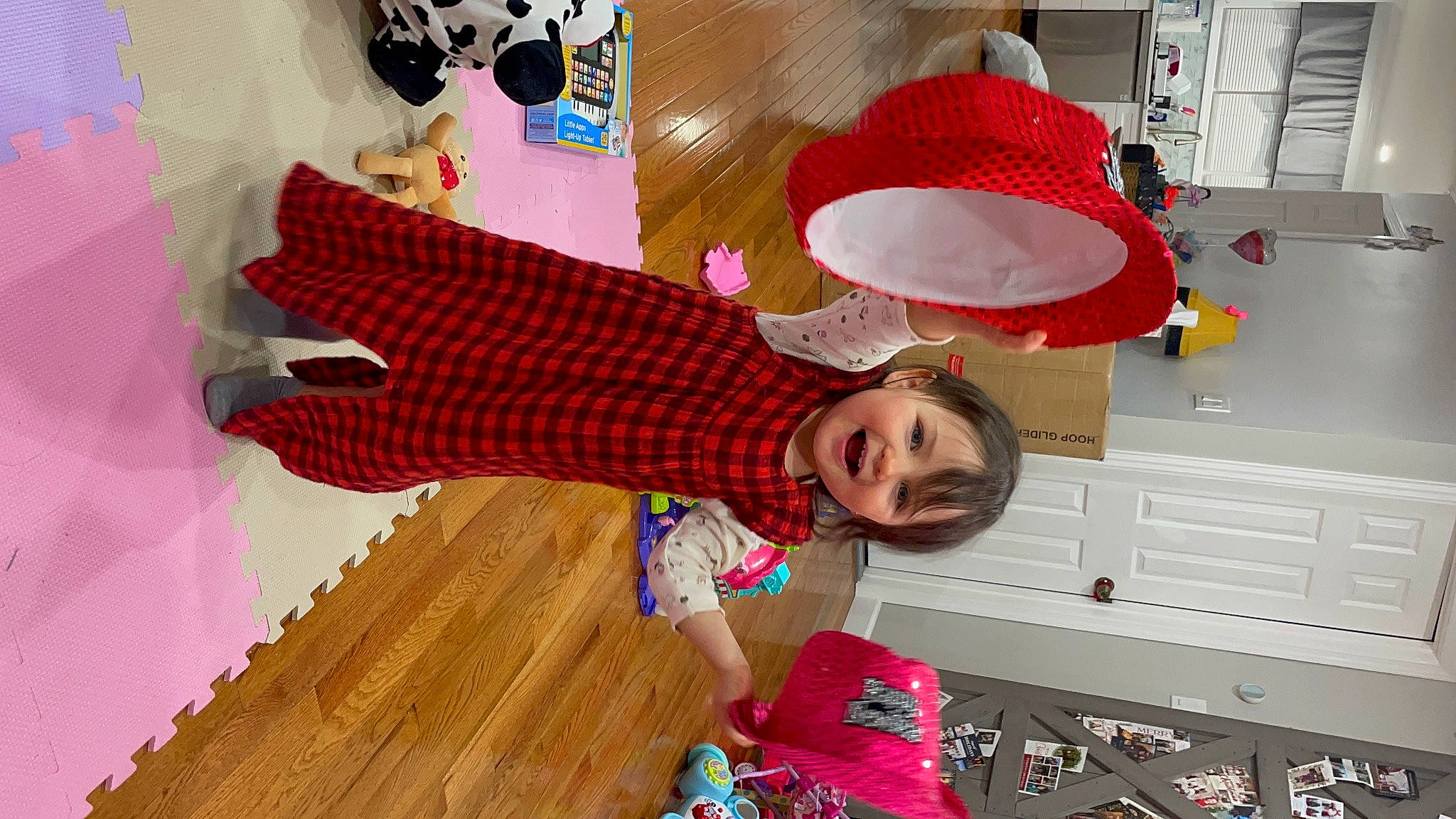 Victoria is registered to the contest to win money with this photo: child, costume, flooring, fun, happy, hardwood, hat, magenta, mammal, pattern, peach, person, pink, play, room, sandal, smile, sun_hat, toddler, toy