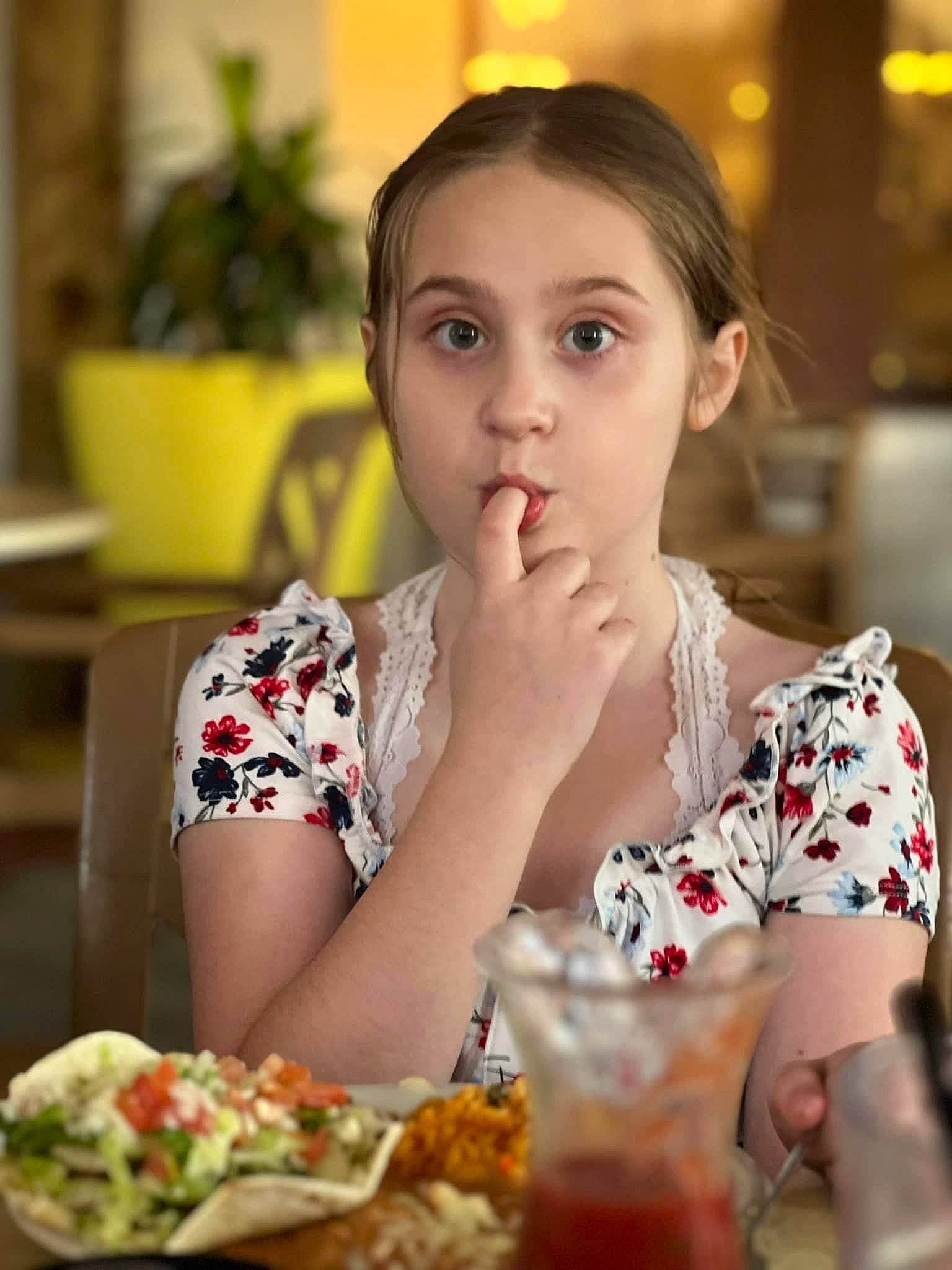 Evie is registered to the contest to win money with this photo: chair, comfort_food, cuisine, dress, drink, drinkware, food, food_craving, happy, houseplant, ingredient, junk_food, lip, person, plant, plate, recipe, soft_drink, sweetness, table