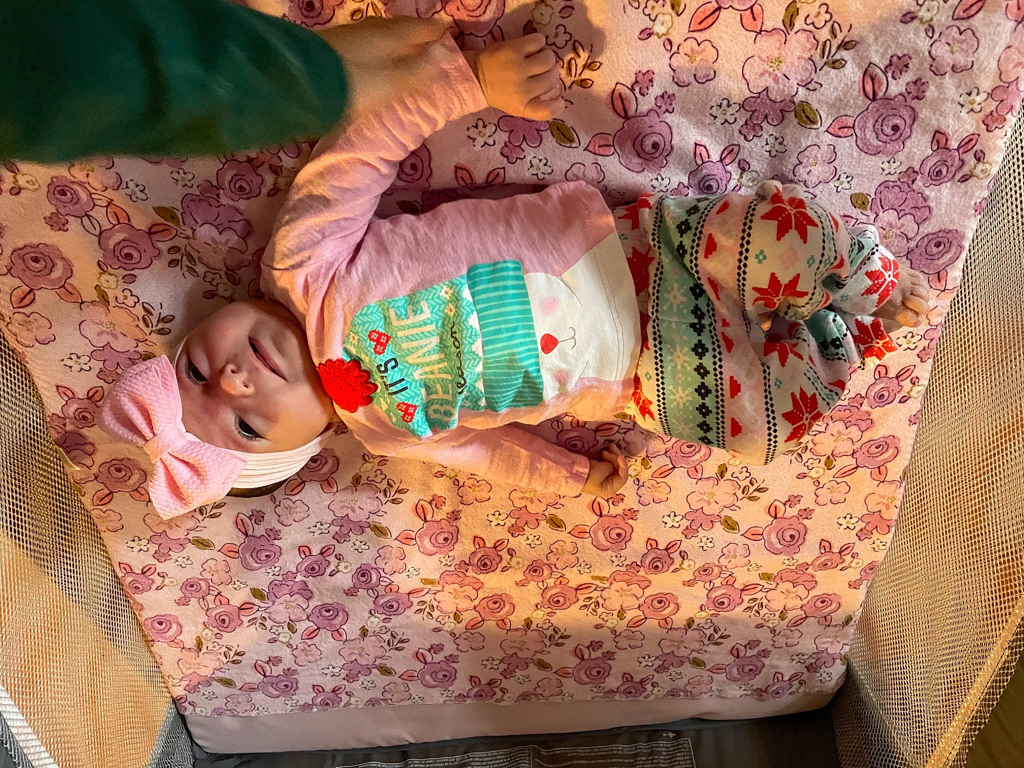 Jayla is registered to the contest to win money with this photo: baby, baby_toddler_clothing, bedding, child, comfort, craft, creative_arts, dress, happy, headwear, linens, magenta, pattern, peach, person, room, sitting, sleeve, toddler, visual_arts