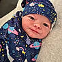 baby, blanket, clouds, cute, face, hat, indoors, infant, moon, newborn, planets, portrait, rainbow, resting, smiling, soft, space_theme, stars, towel, wrapped