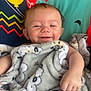 Archer joined the competition — help win amazing prizes! baby, balloon, blanket, child, colorful_background, cozy, cute, elephant, face, hand, happy, indoors, infant, patterned_blanket, playful, portrait, smiling, soft_texture, wrapped, young_child