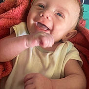 Archer is registered to the contest to win money with this photo: baby, baby_clothes, blanket, blue_eyes, child, colorful_background, cute, expression, face, hand, happy, headband, infant, lying_down, onesie, portrait, red_blanket, skin, smiling, young_child
