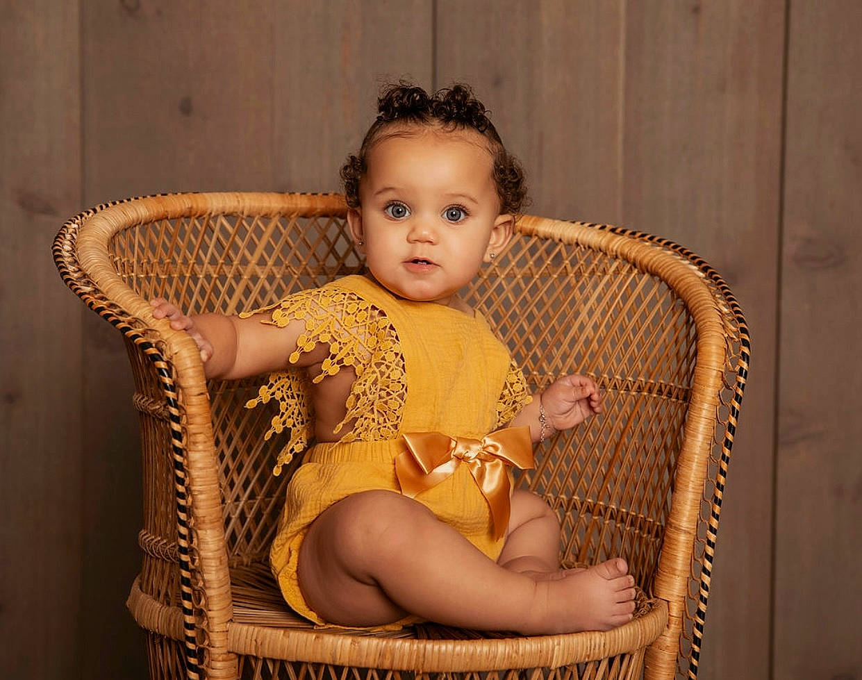 Kapri joined the competition — help win amazing prizes! baby, baby_toddler_clothing, chair, cheek, child, comfort, eye, eyelash, flash_photography, flesh, foot, human_leg, lap, person, sitting, skin, thigh, toddler, wicker, wood