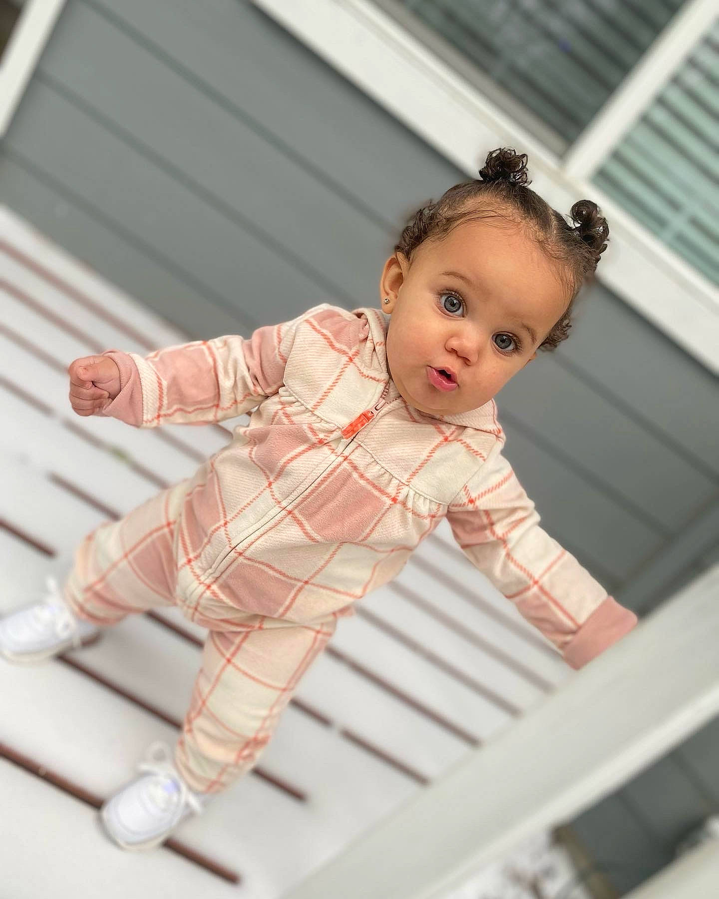 Kapri is registered to the contest to win money with this photo: arm, baby, baby_toddler_clothing, child, dress_shirt, flash_photography, flooring, happy, human_leg, pattern, person, plaid, portrait_photography, sitting, sleeve, sock, standing, surprise, t_shirt, tartan