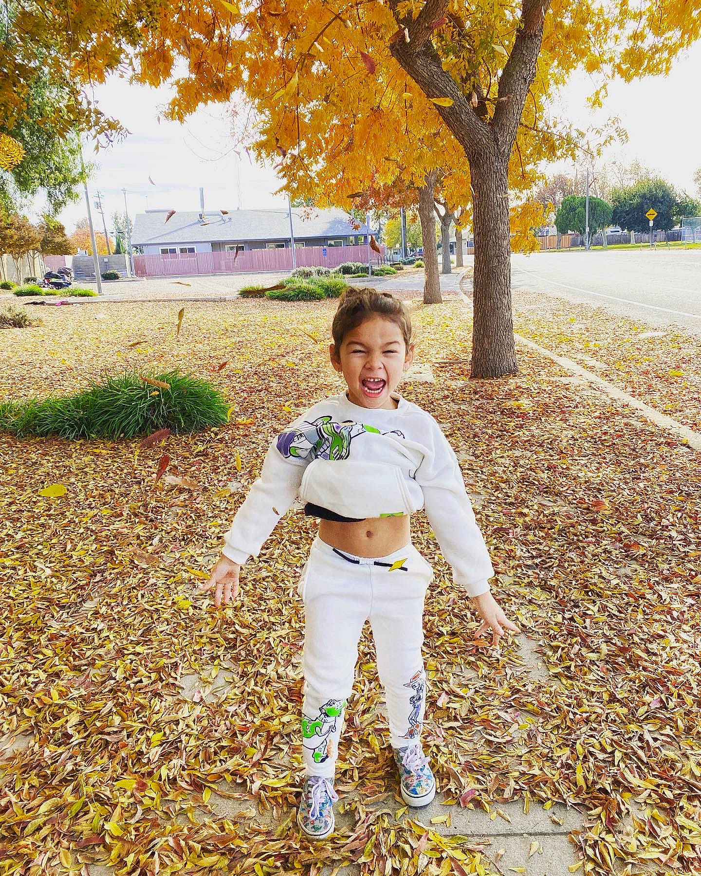 Azariah is registered to the contest to win money with this photo: branch, deciduous, formal_wear, gesture, grass, happy, leaf, leg, leisure, morning, people_in_nature, person, plant, smile, sunlight, tints_and_shades, toddler, tree, waist, woody_plant