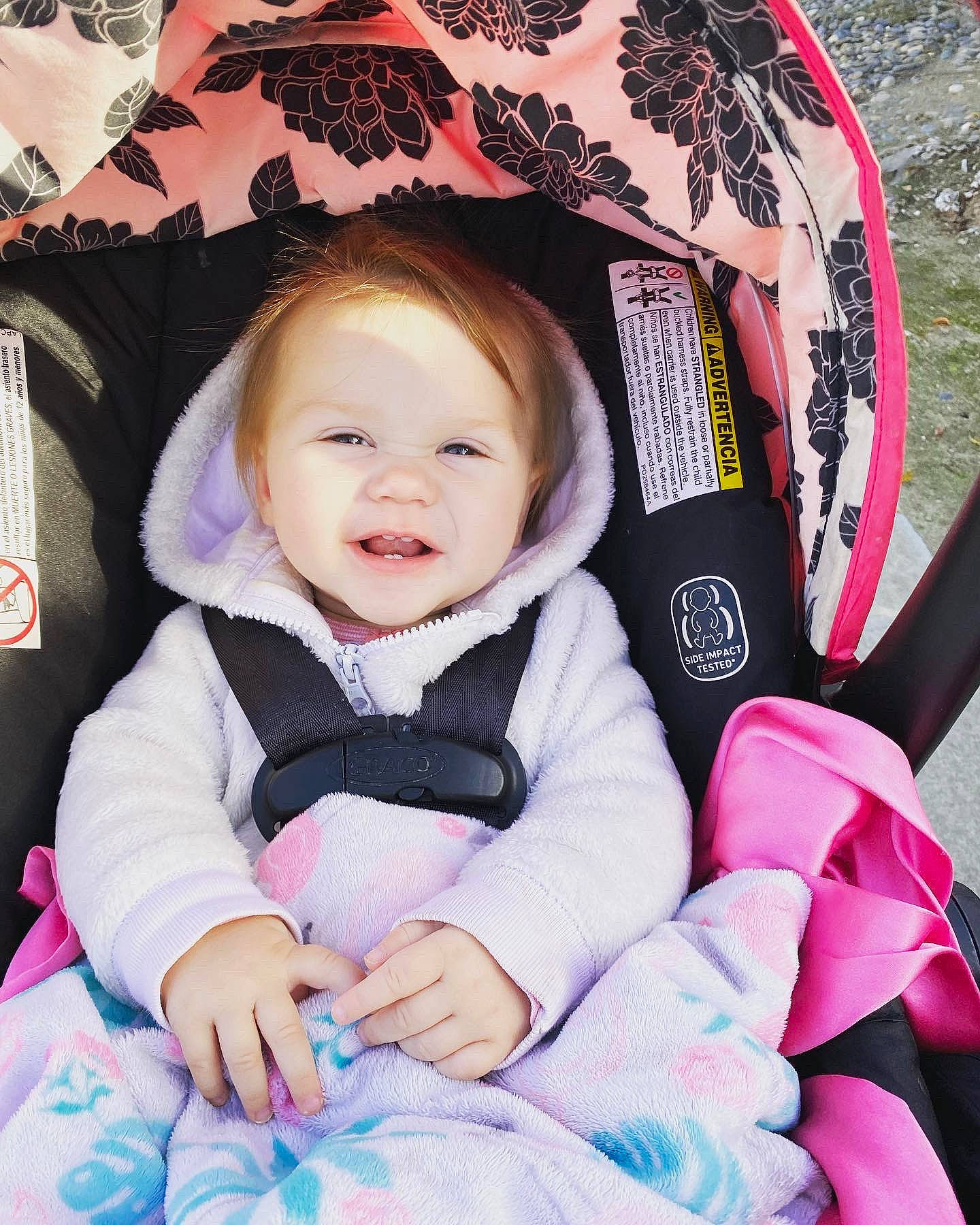 Everleigh is registered to the contest to win money with this photo: baby, baby_carriage, baby_products, baby_toddler_clothing, cheek, child, comfort, facial_expression, fun, happy, iris, magenta, person, pink, purple, skin, sleeve, smile, toddler, travel