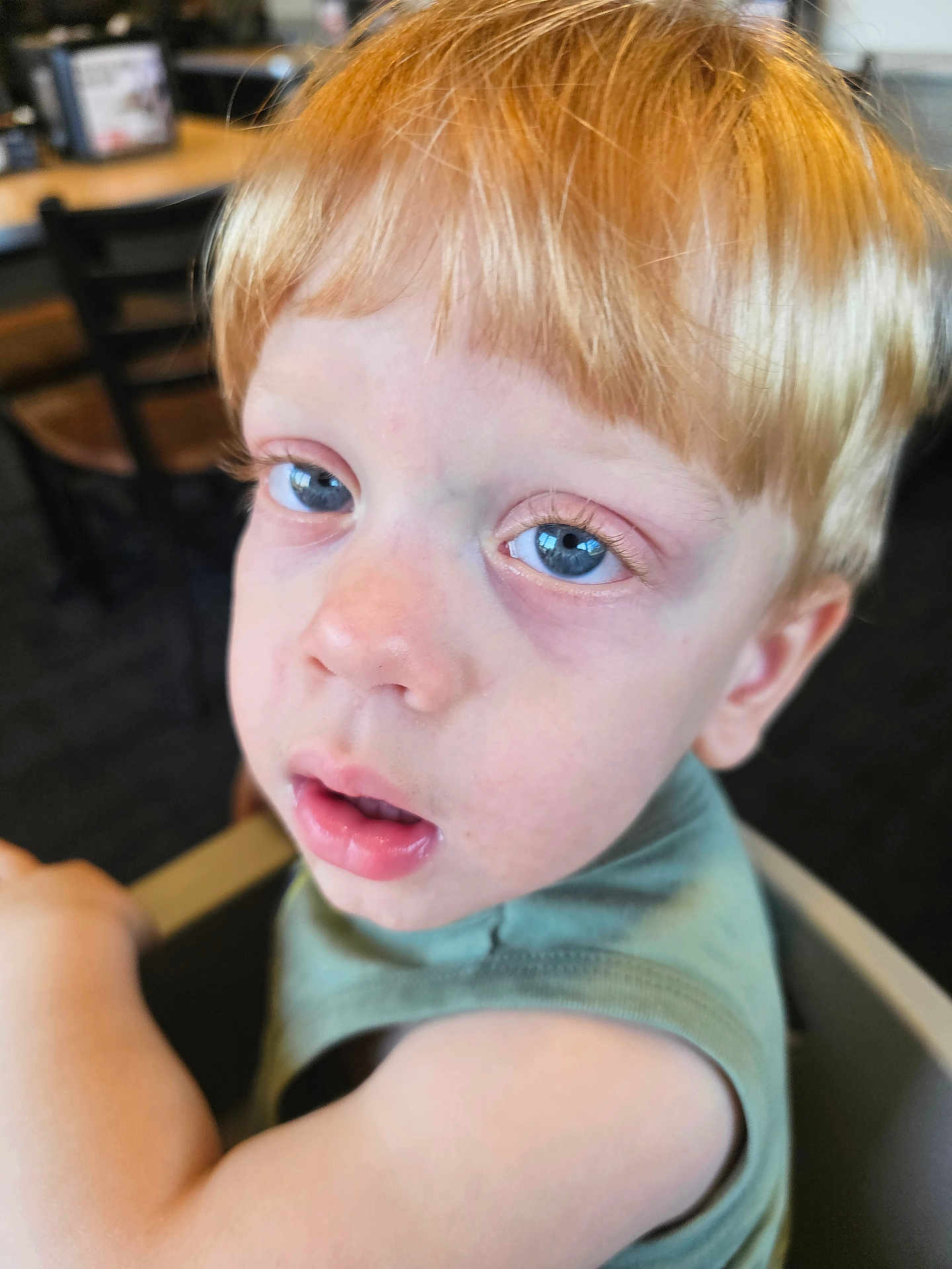 Jadeyn joined the competition — help win amazing prizes! child, blue_eyes, blonde_hair, close_up, indoor, green_shirt, face, person, young_child, tired_look, expression, portrait, skin, eyelashes, nose, mouth, sitting, chair, background_blur, casual_clothing