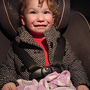 Makenna is registered to the contest to win money with this photo: baby, bodypart, car, car_interior, carseat, clothing, coat, cushion, face, finger, hand, hat, head, homedecor, jacket, person, photography, portrait, transportation, vehicle