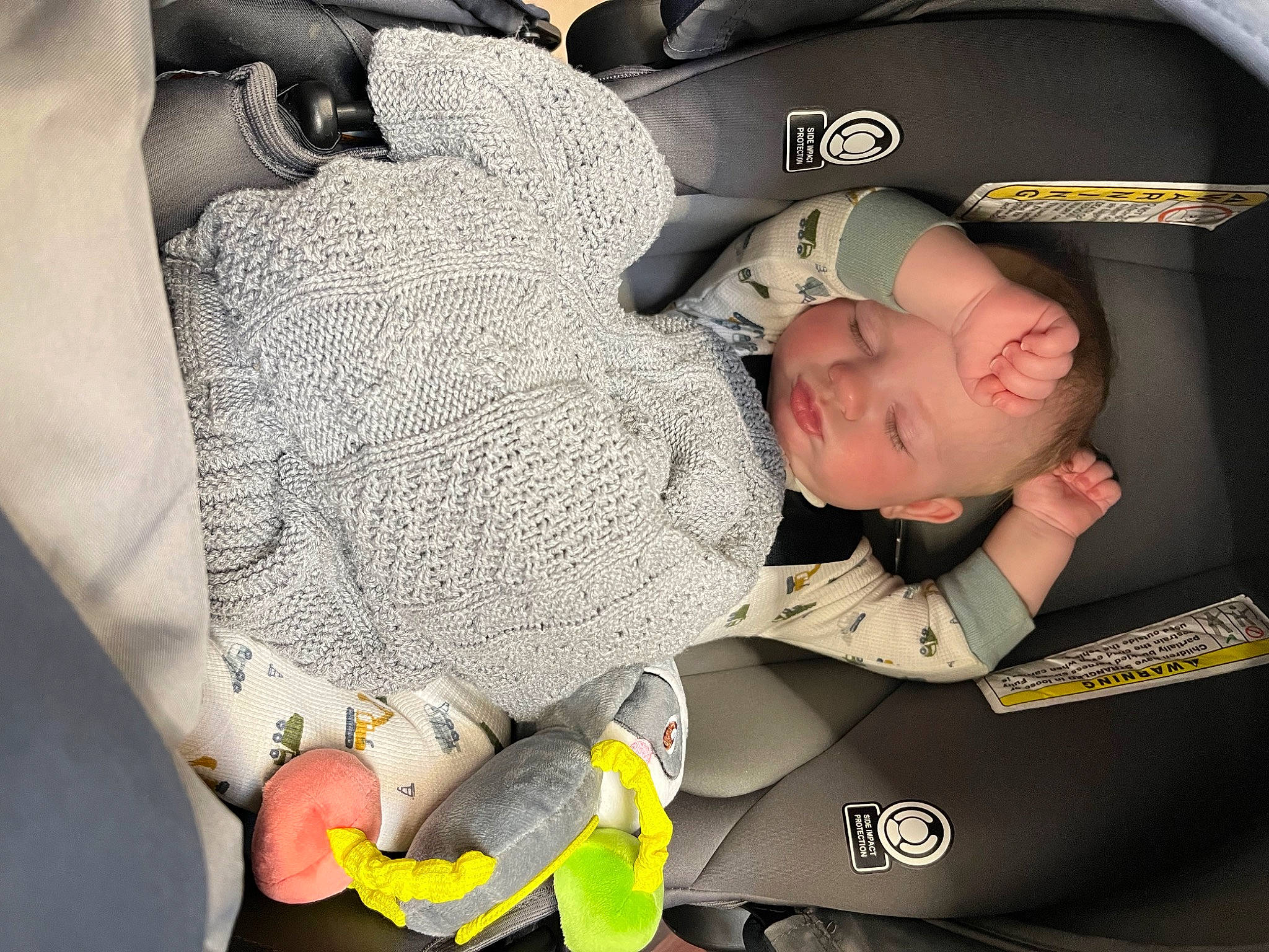 Creed is registered to the contest to win money with this photo: audio_equipment, auto_part, baby, baby_carriage, baby_products, baby_sleeping, car_seat, child, comfort, fashion_accessory, finger, font, gesture, happy, pattern, person, personal_protective_equipment, room, sitting, thigh