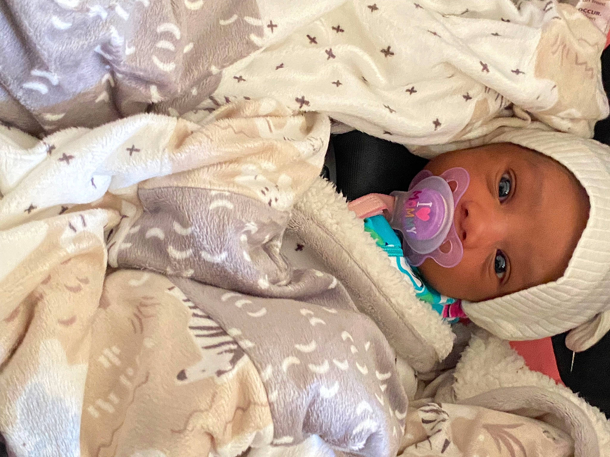 Ariana is registered to the contest to win money with this photo: baby, baby_products, baby_toddler_clothing, cheek, child, comfort, fun, happy, hat, headwear, iris, linens, pattern, person, room, sitting, sleeve, smile, toddler, wood