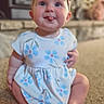 baby, child, girl, sitting, carpet, dress, floral_pattern, headband, purple_bow, tongue_out, indoor, fireplace, blurred_background, cute, happy, smiling, person, infant, portrait, playful