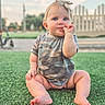 baby, child, grass, outdoor, onesie, headband, cute, sitting, thumb_sucking, blue_eyes, infant, summer, portrait, nature, green, fence, sky, daylight, happy, casual_clothing