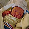 Rythym is registered to the contest to win money with this photo: baby, bedding, blanket, cap, closeup, cozy, eyes_closed, face, hat, hospital, indoors, infant, newborn, peaceful, portrait, resting, sleeping, striped_fabric, swaddled, tiny_hand
