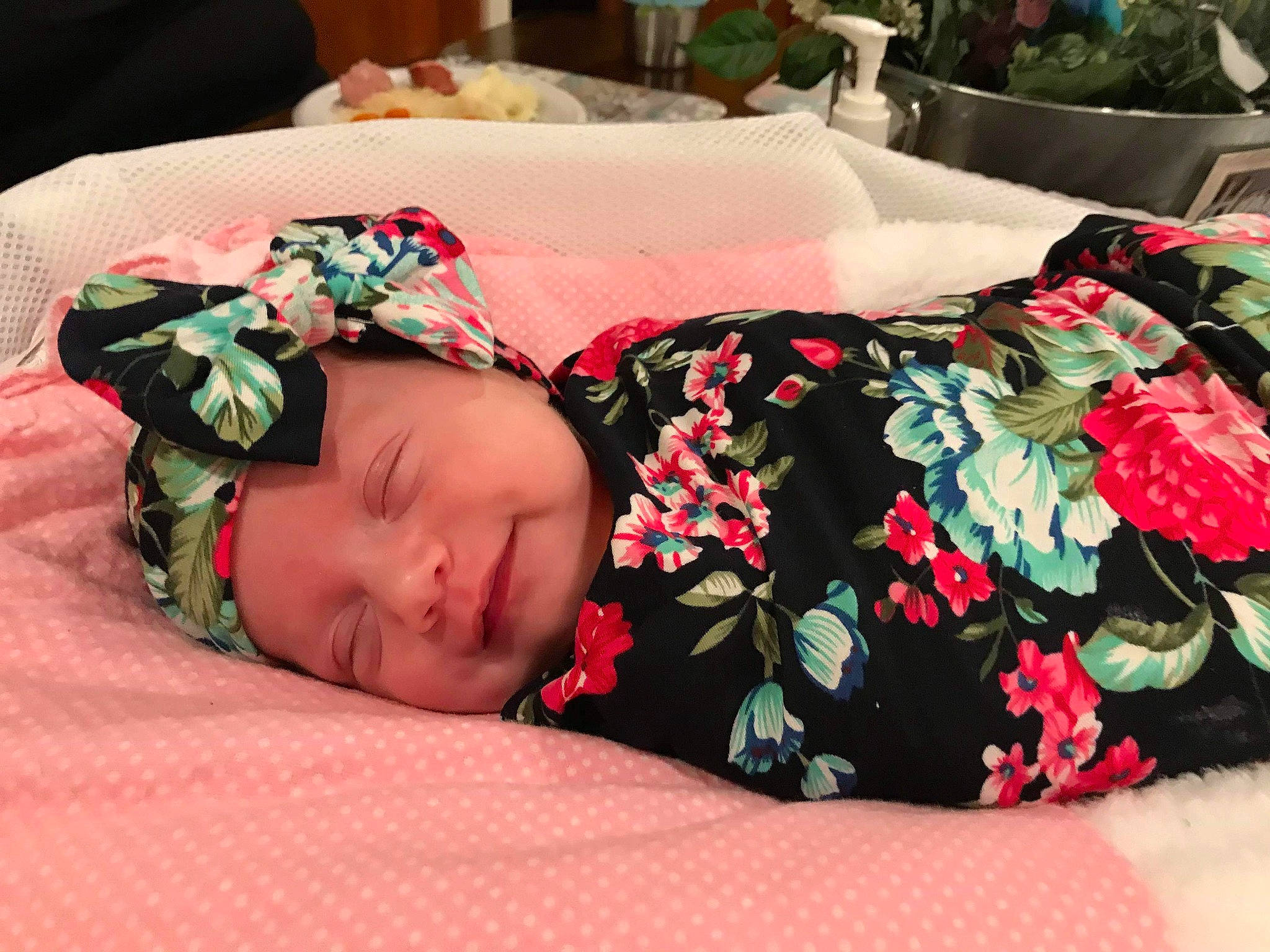 Briana is registered to the contest to win money with this photo: baby, bedding, bedtime, birth, child, flower, furniture, headwear, linens, nap, person, plant, room, sleep, textile