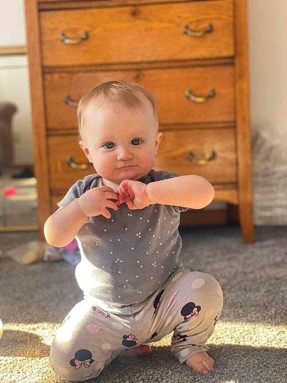 Ariana joined the competition — help win amazing prizes! baby, baby_toddler_clothing, cabinetry, chest, chest_of_drawers, child, drawer, dresser, eye, floor, flooring, furniture, happy, hardwood, knee, person, sleeve, toddler, white, wood