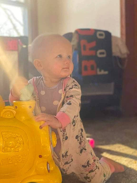 Kyla joined the competition — help win amazing prizes! baby, child, flooring, fun, happy, leisure, person, personal_protective_equipment, plastic, play, recreation, riding_toy, room, sitting, toddler, yellow