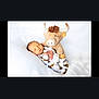 baby, newborn, sleeping, stuffed_animal, bull, toy, white_background, infant, cute, soft, cozy, child, peaceful, resting, pajamas, patterned_clothing, hands, face, lying_down, indoors