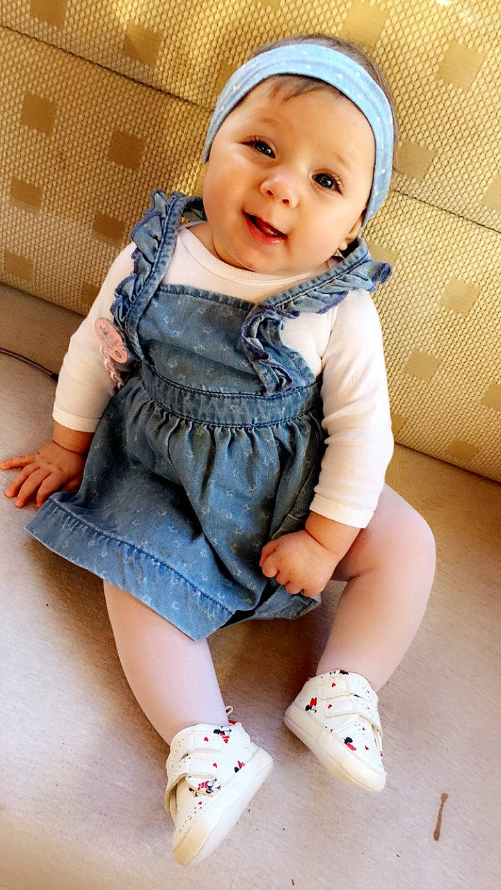 Shaynna participe au concours pour gagner de l'argent avec cette photo : baby, baby_products, baby_toddler_clothing, beauty, cheek, child, child_model, footwear, headgear, leg, outerwear, pattern, person, pink, product, shoe, sitting, skin, sleeve, toddler