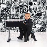 Giovanni joined the competition — help win amazing prizes! baby, tuxedo, piano, black_and_white, collage, smile, child, portrait, cute, musical_instrument, floor_reflection, indoor, formal_clothing, seat, photography, background, studio, small_piano, happy, infant