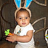 baby, bunny_ears, toy, carrot, child, cute, costume, face, floor, indoor, infant, person, portrait, sitting, tile_floor, white_clothing, headwear, playful, smiling, young_child