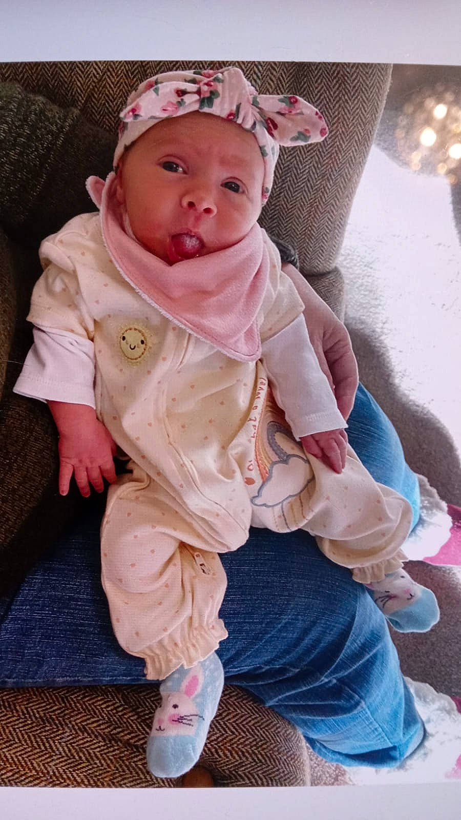 Lily joined the competition — help win amazing prizes! baby, baby_products, baby_toddler_clothing, beanie, cap, cheek, child, fashion_accessory, flooring, fur, headwear, hood, lip, peach, person, personal_protective_equipment, pink, sandal, sitting, skin