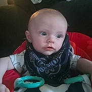 Abel joined the competition — help win amazing prizes! baby, child, bandana, bib, red_seat, toy_ring, indoor, curious, face, person, infant, blue_eyes, clothing, sitting, comfort, young, cute, holding, portrait, home