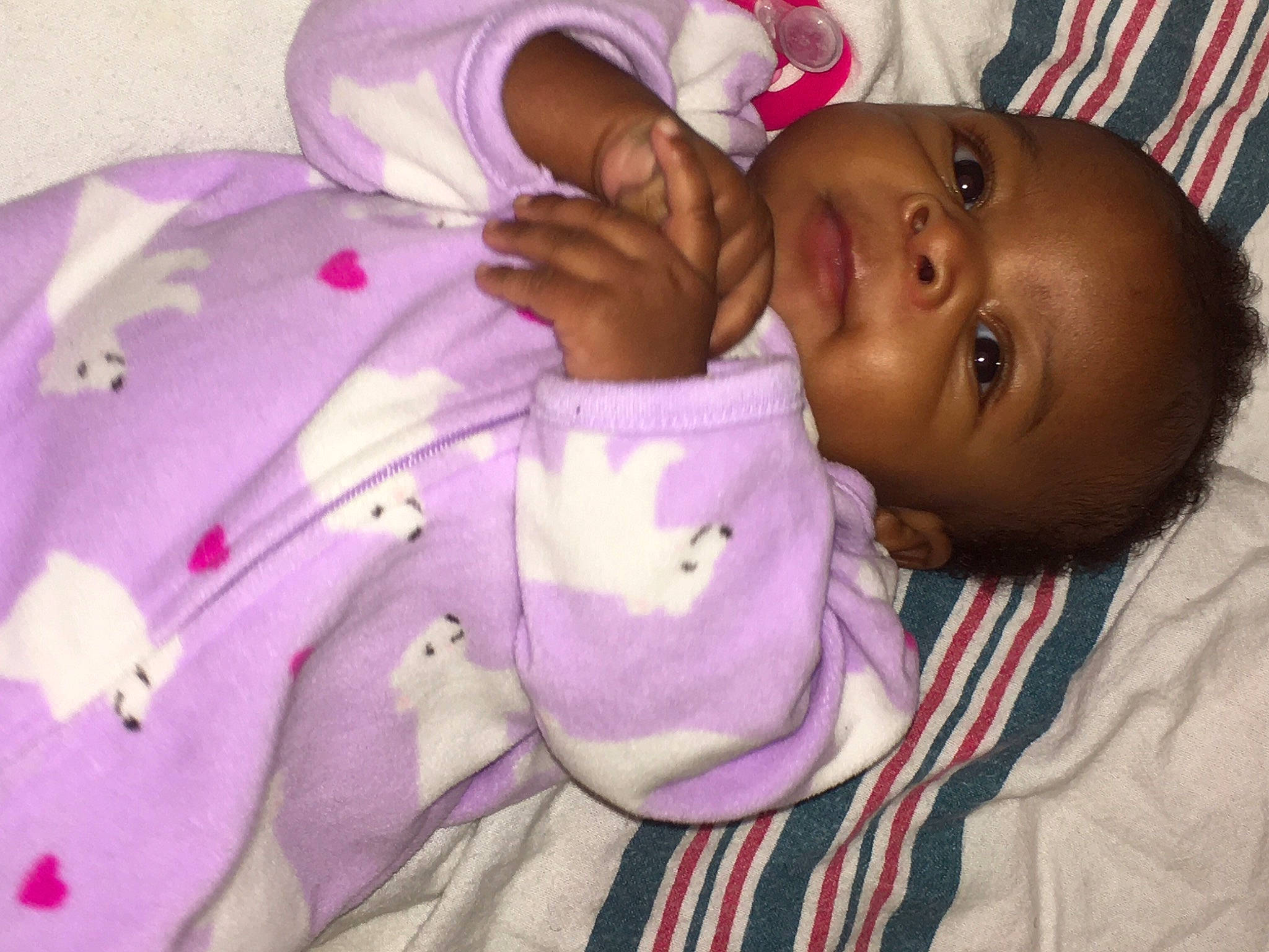 Za'Niyah is registered to the contest to win money with this photo: baby, baby_products, baby_toddler_clothing, cheek, child, comfort, gesture, happy, linens, lip, magenta, nose, person, petal, pink, purple, skin, sleeve, smile, toddler