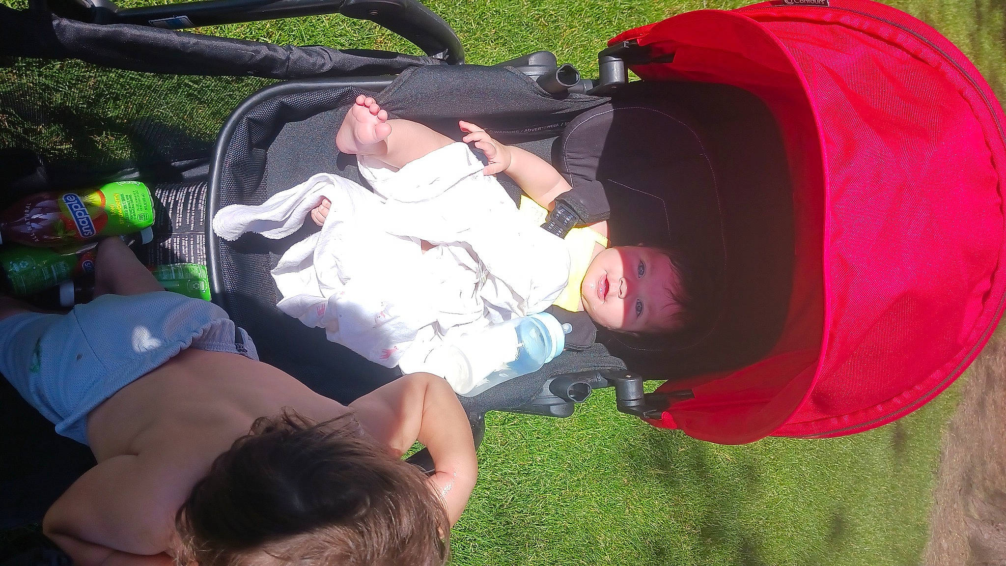 Jeslianny is registered to the contest to win money with this photo: baby, backpack, bag, baseball_cap, child, comfort, event, fun, grass, green, happy, lap, lawn, leisure, luggage_and_bags, person, recreation, sitting, t_shirt, toddler