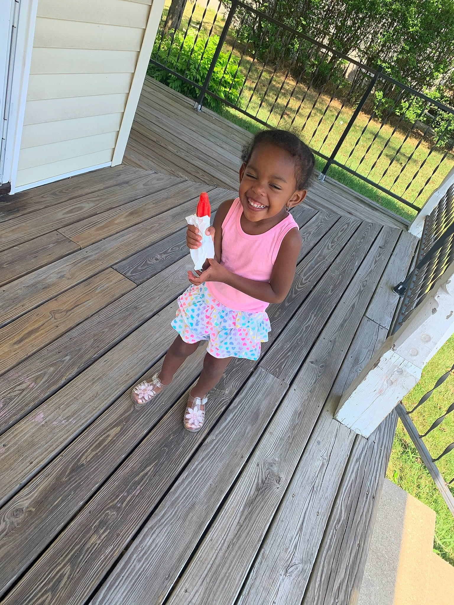 Amaria is registered to the contest to win money with this photo: child, deck, floor, flooring, home, joy, leisure, outdoor_structure, pattern, person, play, porch, sitting, summer, table, toddler, vacation, wood, wood_stain