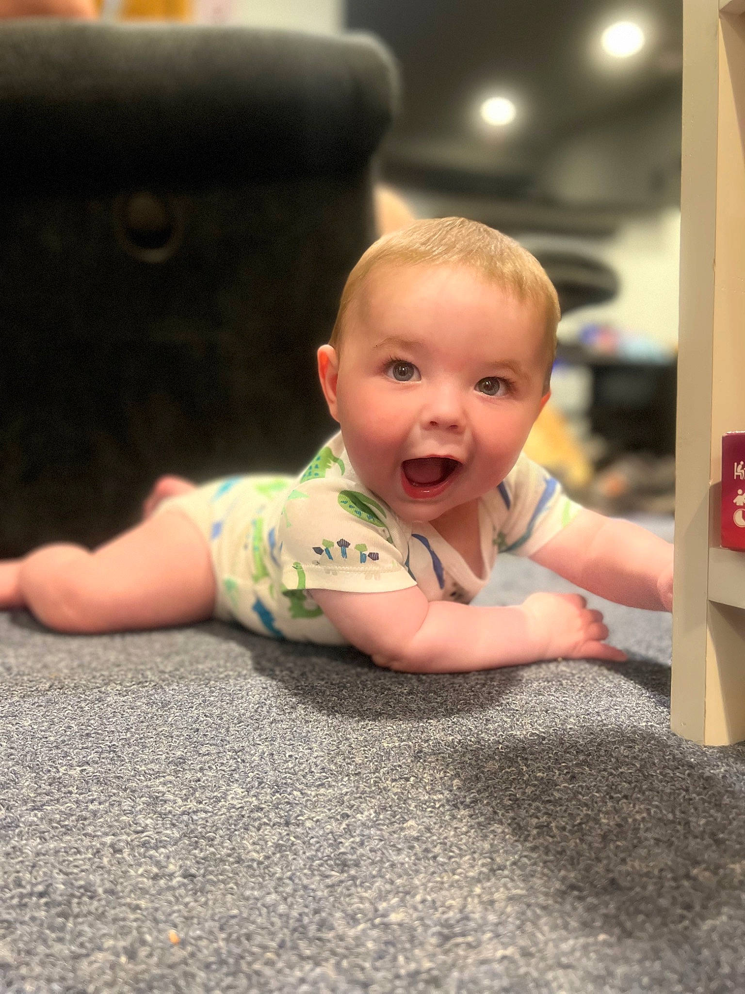 Alexander is registered to the contest to win money with this photo: asphalt, baby, cheek, child, comfort, crawling, flash_photography, floor, flooring, fun, happy, hardwood, human_leg, person, road_surface, sitting, skin, smile, t_shirt, toddler