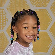 Madison is registered to the contest to win money with this photo: beads, braided_hair, child, clothing, colorful, cute, earring, face, fashion, girl, happy, innocence, pattern, person, photography, portrait, smile, studio, yellow_background, young