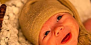 Xavier is registered to the contest to win money with this photo: baby, infant, hat, knit_hat, blanket, white_blanket, smile, happy, face, eyes, skin, newborn, cute, portrait, closeup, warm_lighting, soft_texture, cozy, child, indoors