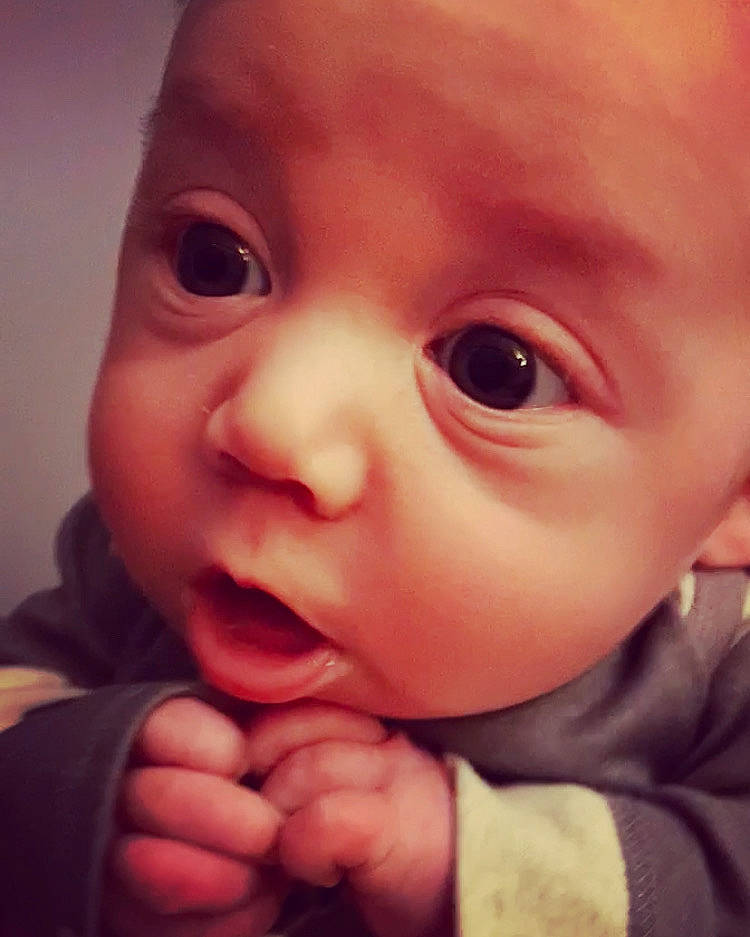 Bowen is registered to the contest to win money with this photo: baby, cheek, ear, eyebrow, eyelash, finger, forehead, gesture, happy, iris, jaw, lip, mouth, nose, person, pink, skin, sleeve, smile, toddler