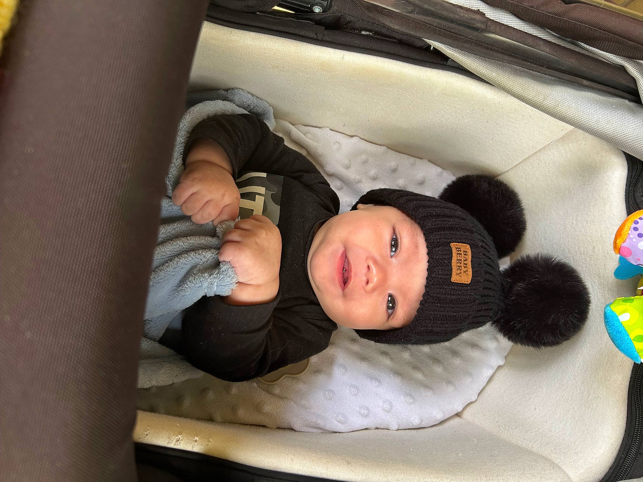 Malakai is registered to the contest to win money with this photo: baby, baby_products, baby_toddler_clothing, car_seat, child, comfort, couch, doll, fur, headwear, infant_bed, linens, luxury_vehicle, person, room, sitting, toddler, toy, tree, wood