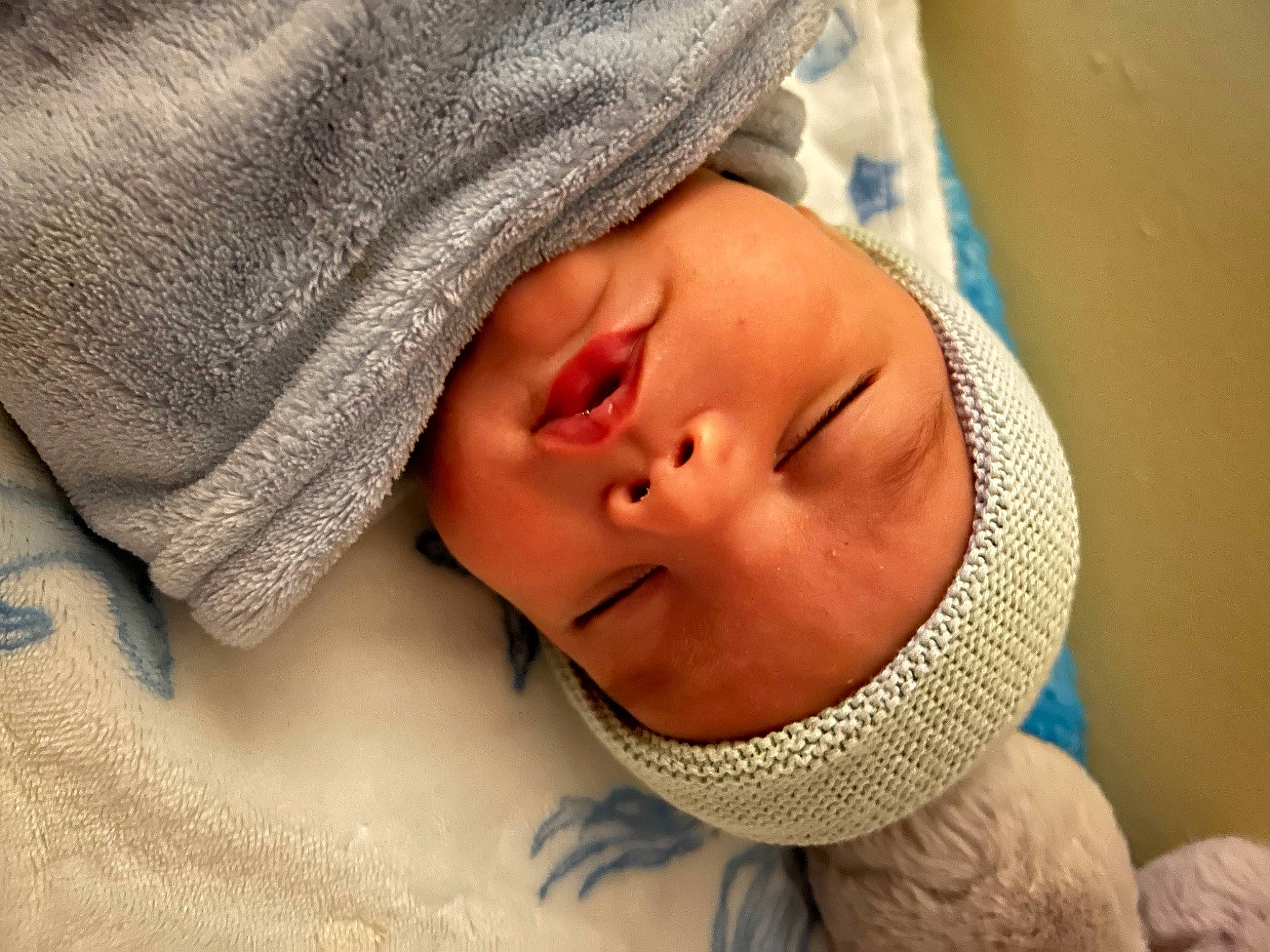 Malakai is registered to the contest to win money with this photo: baby, baby_sleeping, bedtime, cap, cheek, childbirth, comfort, eye, eyebrow, eyelash, face, happy, headwear, linens, mouth, neck, nose, person, room, skin