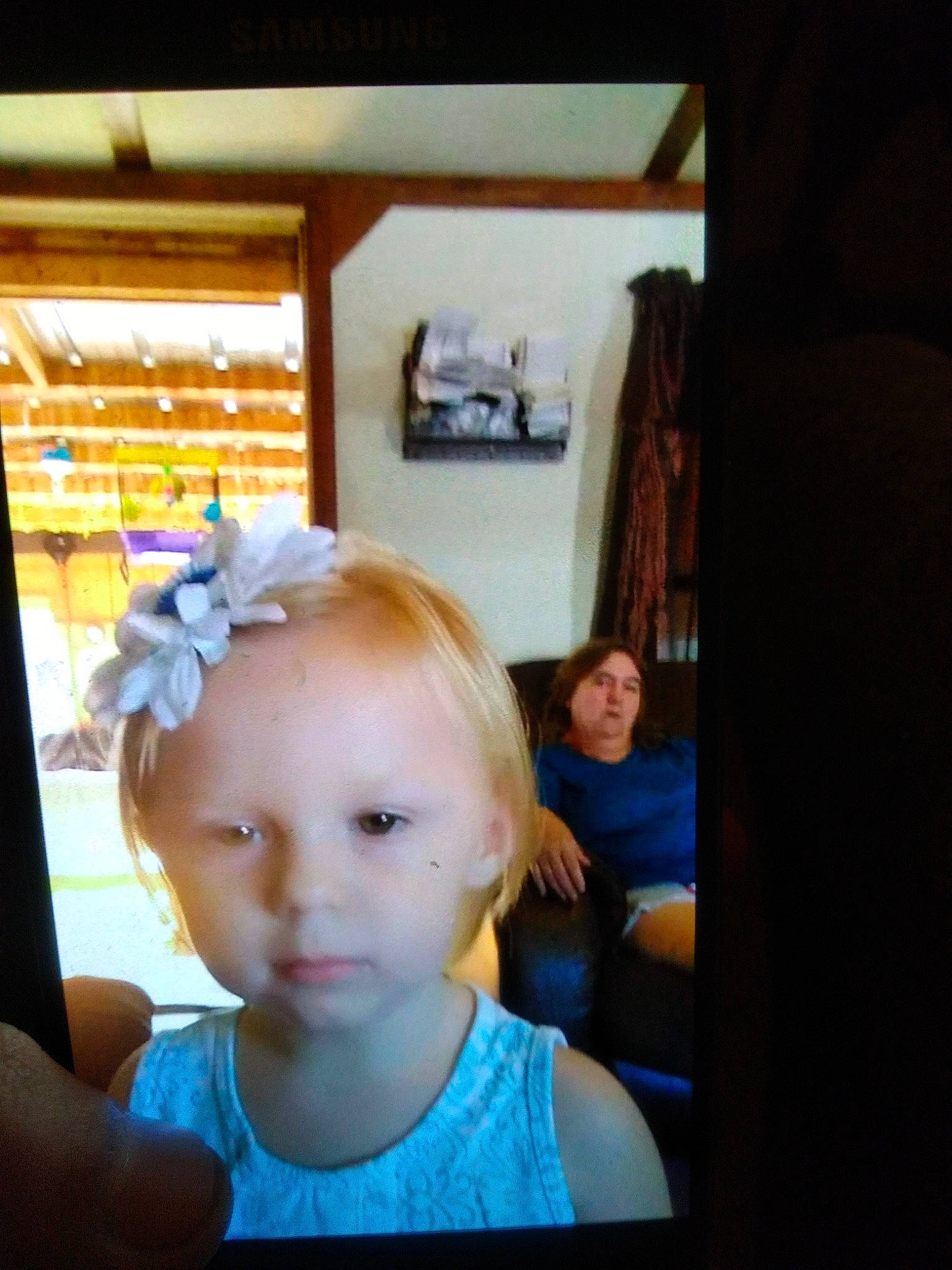 Taylor is registered to the contest to win money with this photo: baby_toddler_clothing, chair, child, electric_blue, electronic_device, event, eyelash, eyewear, fashion_accessory, fun, gadget, hair_coloring, happy, headband, headpiece, person, room, selfie, sitting, t_shirt