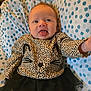 Samantha joined the competition — help win amazing prizes! baby, infant, smiling, leopard_print, cat_face, shirt, tutu, black_skirt, blanket, polka_dot, blue, white, cute, tongue_out, happy, child, clothing, portrait, indoor, person