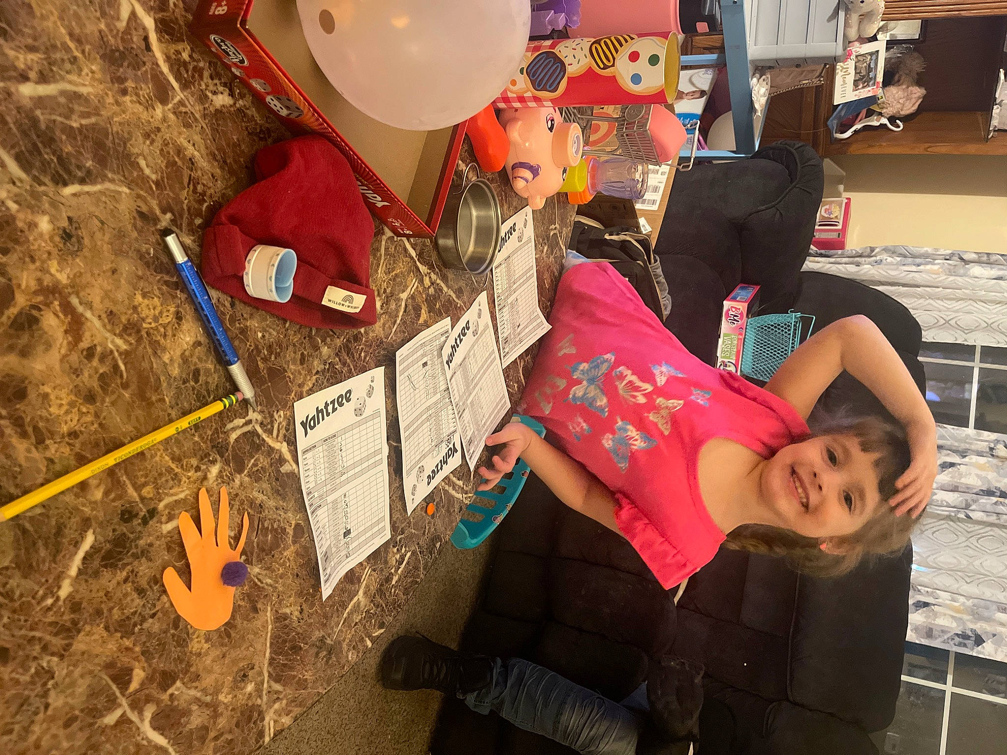 Thea is registered to the contest to win money with this photo: child, event, fun, hat, joy, leisure, person, plastic, product, sandal, sitting, soil, sun_hat, t_shirt, textile, thigh, tire, toddler, tree, visual_arts